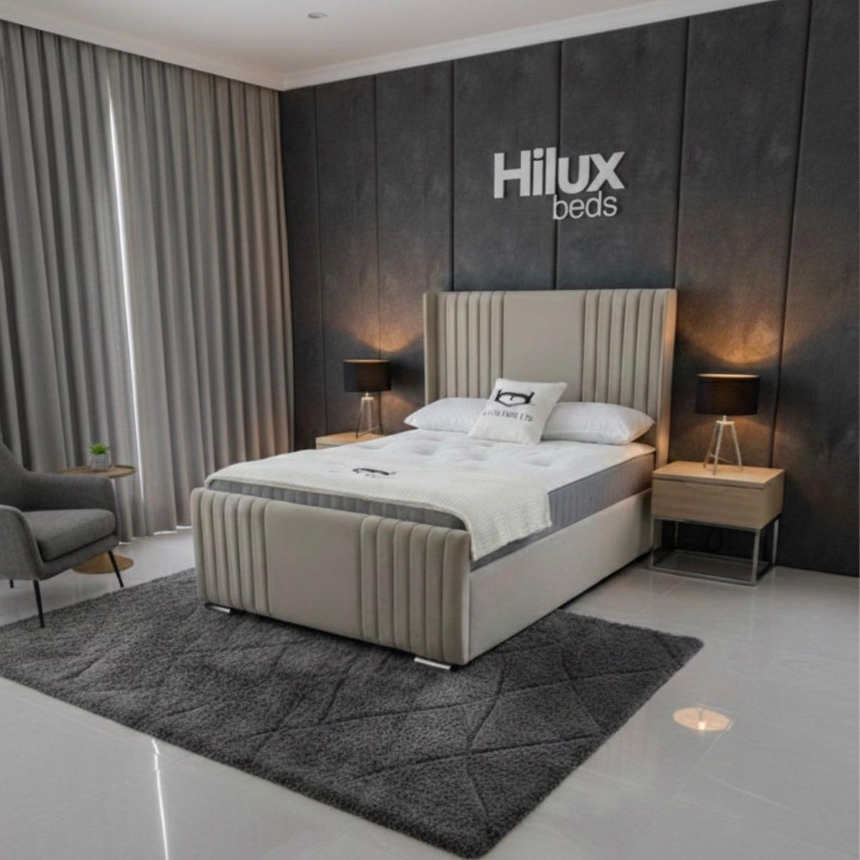Modern bedroom with a bed and 'Hilux beds' branding on the wall.