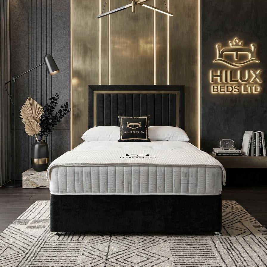 Modern bedroom with a bed and 'Hilux Beds Ltd' logo on the wall.